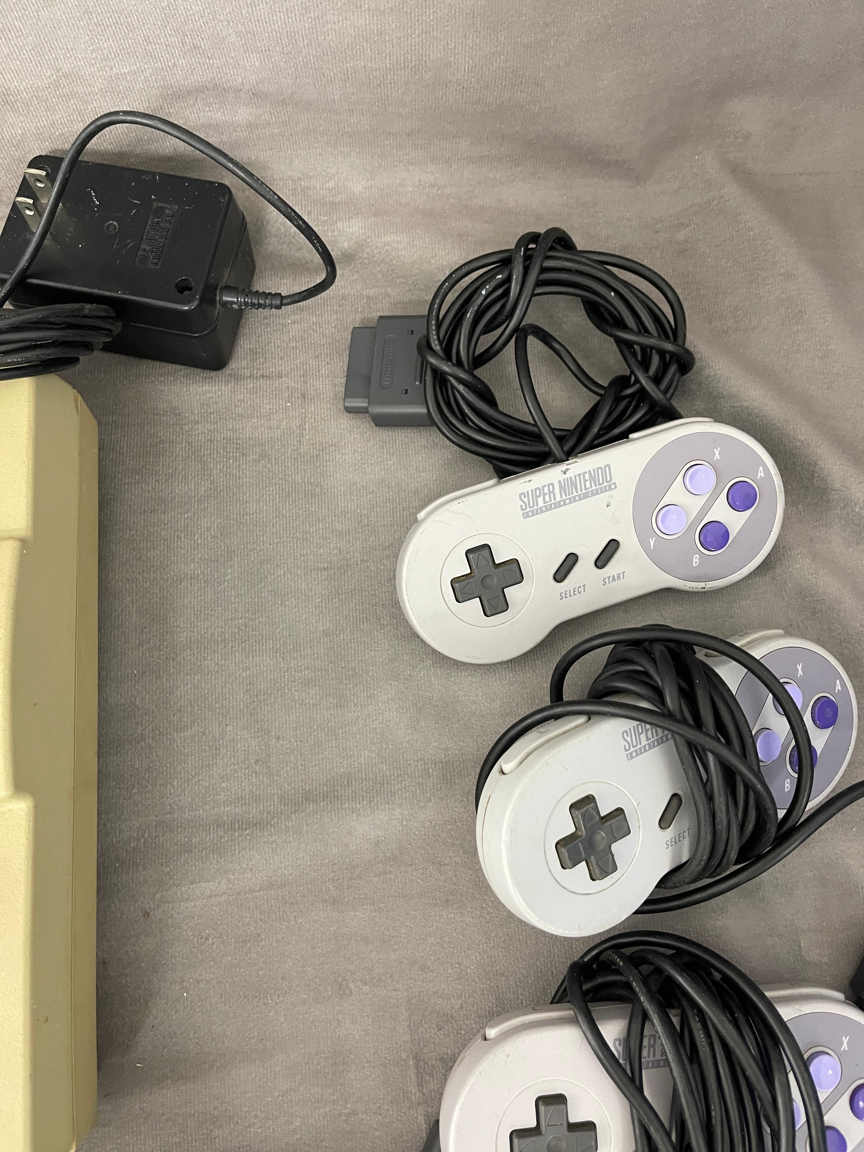Super Nintendo Entertainment Systems with Controllers Games and Cables