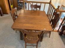 Oak square ornate table with rope legs, 4 matching chairs and 5 leaves. Excellent!!