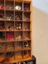 Knick knack shelves with costume jewelry.