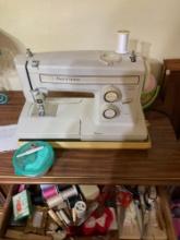 kenmore sewing machine in case desk with pin cushion and pins and sowing threads, and chair All goes