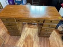 Nice wooden desk with lots of drawers.