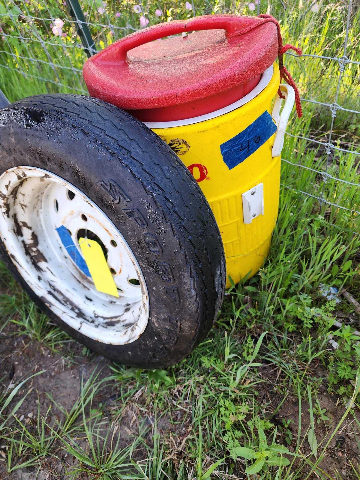 Small tire on rim and 5 gal Igloo water jug. used.