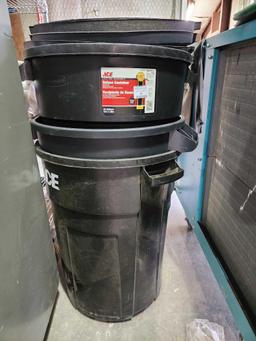 Three black plastic 33 gal trash cans with lids....