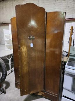 Large wood veneer armoire. Used, damaged base. 46" x 76" x 19".