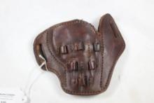 One dark brown belt holster with cartridge loops. Used. Right handed.