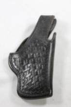 One Kirkpatrick black basketweave leather snap belt holster. Used, right handed