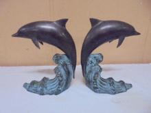Set of Metal Dolphins on Wave