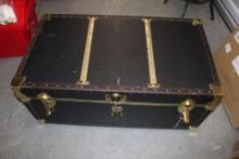 Large Black and Gold rolling trunk.