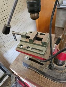 Drill press on rolling table.