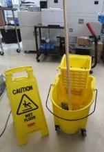 commercial mop bucket and wet floor sign