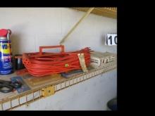 Extension cord, trimmer, box cutter and mix on garage shelf