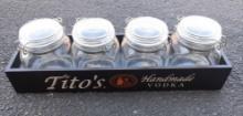 Tito's vodka display and 4 tito's glass containers