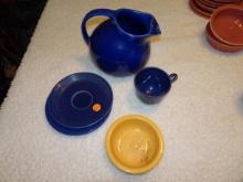 Dark Blue Fiesta Ware Saucers, Cups, Pitcher & 1 Yellow Fiesta Ware Bowl