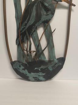 METAL SCULPTURE OF HERON IN THE MARSH