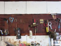 Lot of assorted tools and hardware on pegboard