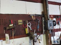 Lot of assorted tools and hardware on pegboard