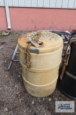 Plastic 50 gallon barrels with water line and PVC pipe