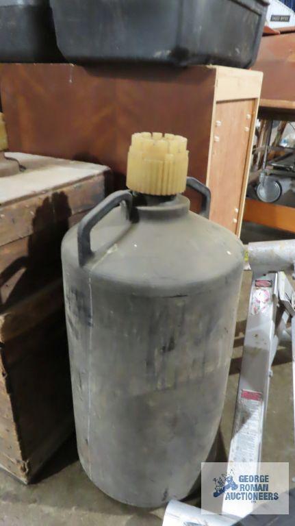Two vintage chemical bottles. One of them has the original crate
