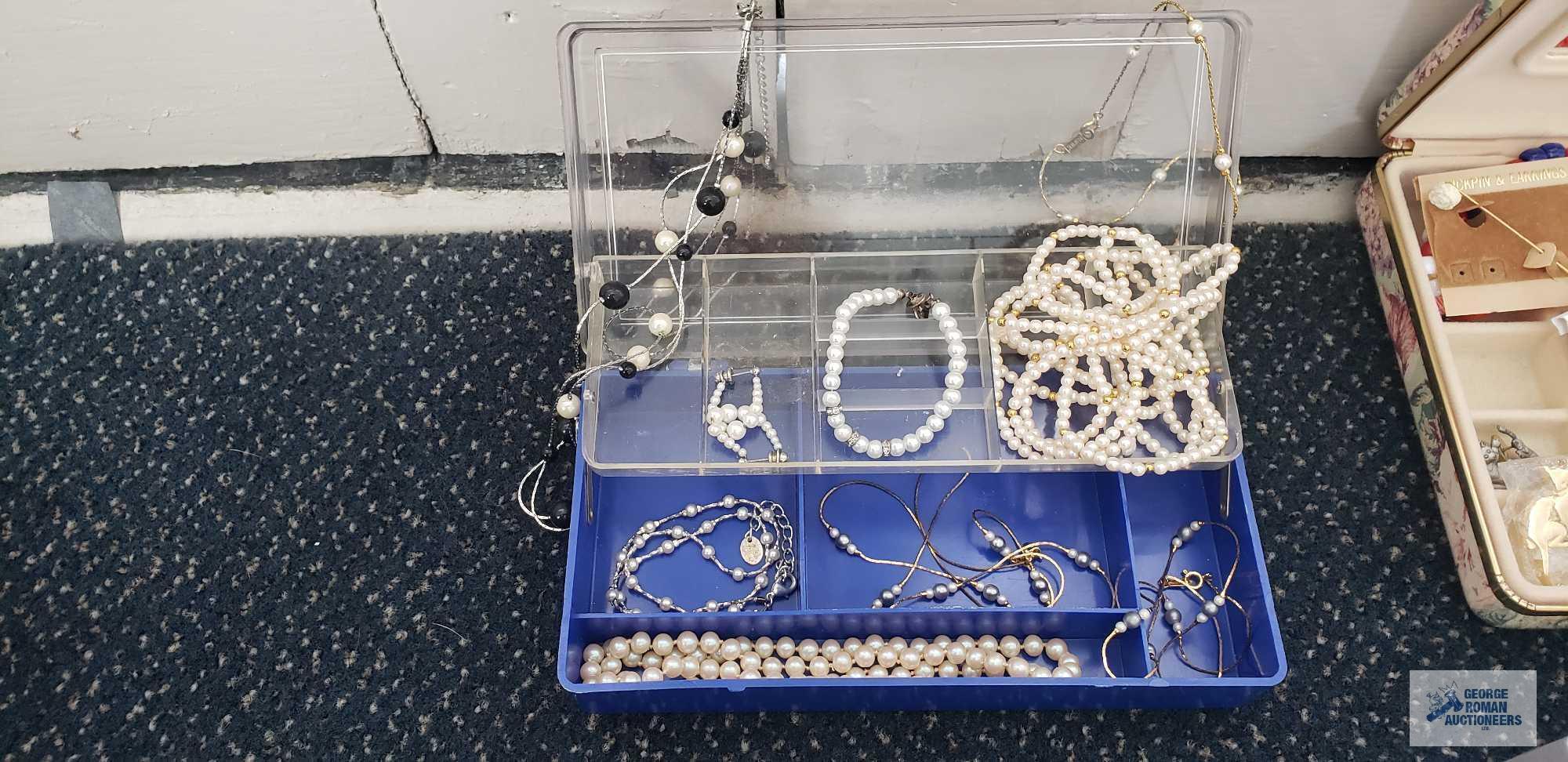 Pearl like costume jewelry in clear plastic divided container