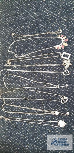 Silver colored costume jewelry necklaces