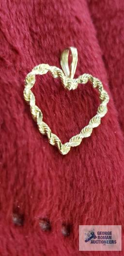 Gold colored heart-shaped pendant, marked 14K, approximate total weight....67 G