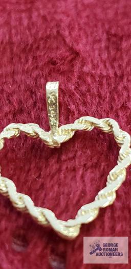 Gold colored heart-shaped pendant, marked 14K, approximate total weight....67 G