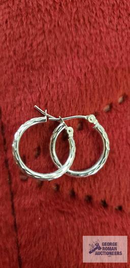 Silver colored hoop earrings, marked 14K Israel, approximate total weight is .82 G