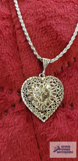 Silver colored cut out heart pendant, marked 925, on silver colored rope chain, marked 925,