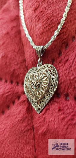 Silver colored cut out heart pendant, marked 925, on silver colored rope chain, marked 925,