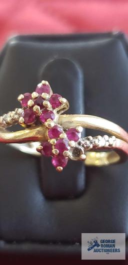 Gold...colored ring with red floral gemstones and clear gemstones on band, marked 14K, missing one r