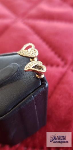 Gold colored heart-shaped earrings, marked 14K, total approximate weight without back is .51 G