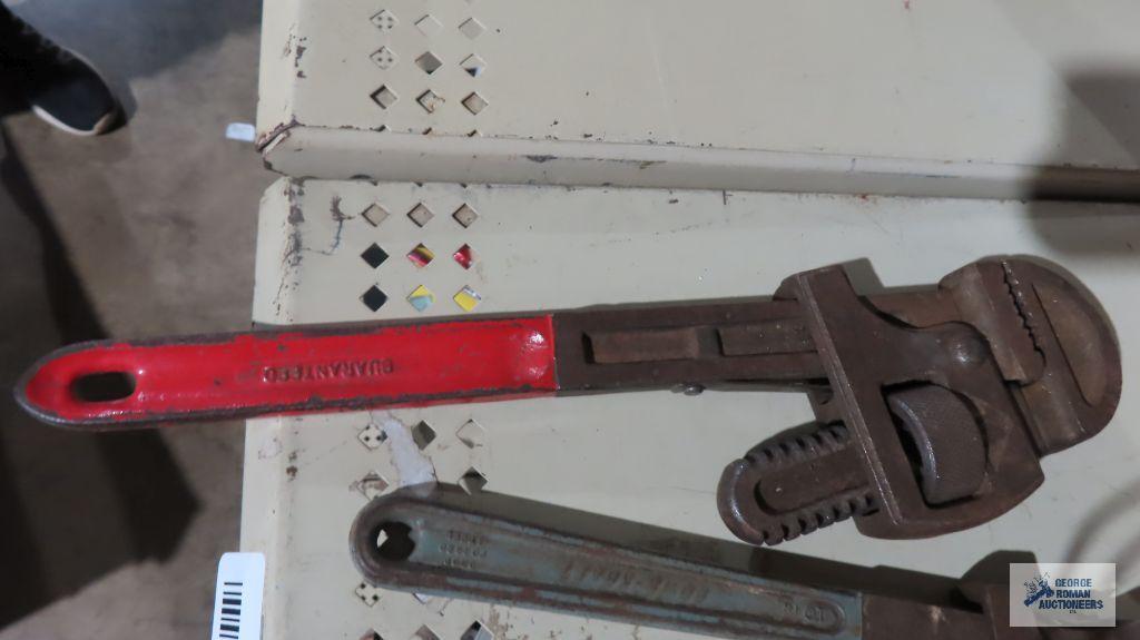 Pipe wrenches, measuring tape, and square