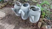 Three antique watering cans