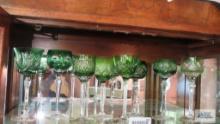 Shelf of decorative green...goblets and white glasses, all etched