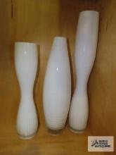 Three decorative white vases