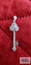 Silver colored key pendant with purple gemstones marked 925 4.1 G (Description provided by seller)