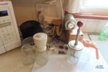 Miscellaneous kitchen items, including plastic bowls,...measuring cups, cookie...press, small scales