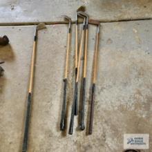 Vintage wooden golf club and metal golf clubs