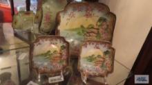 Three I&CE Co. hand painted bowls on display holders