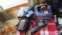 Canon PowerShot SX200 is camera in Nikon Coolpix S9100 camera. Both have boxes. Only one camera