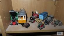 Lot of assorted train cars, toy tractor, wagon, and etc