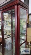 Cherry finish lighted curio cabinet with sliding door and key