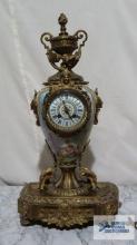 Antique metal and porcelain clock with key. Workings are made in France. 24 in. tall.