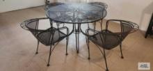 wrought iron patio set, round table and four chairs