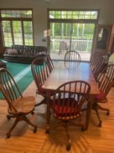 Dining table w/ 8 swivel rolling chairs