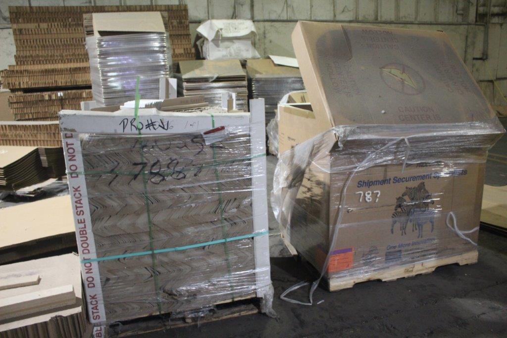All Remaining Cardboard Packaging Components In Corner of Warehouse as Mark