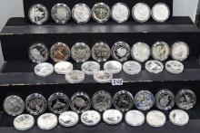 41 MIXED SILVER COMMEMORATIVE ROUNDS IN CAPSULES