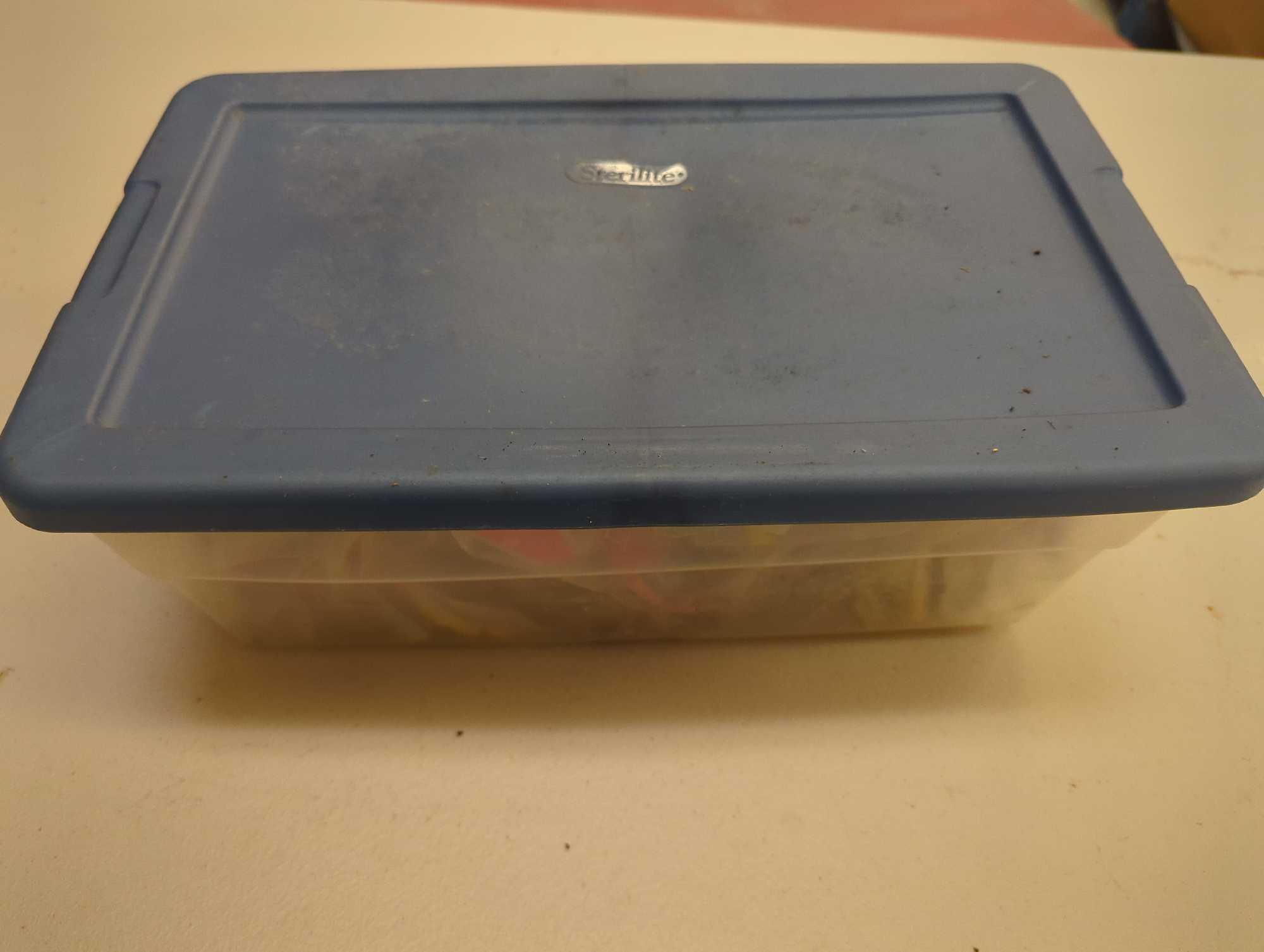 Blue Sterilite organizer tote and contents including worms and other various fishing lures. Comes as