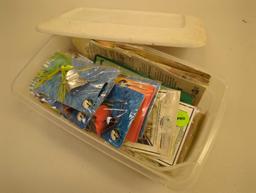 White Sterilite organizer tote filled with packaged fishing lures. Comes as is shown in photos.