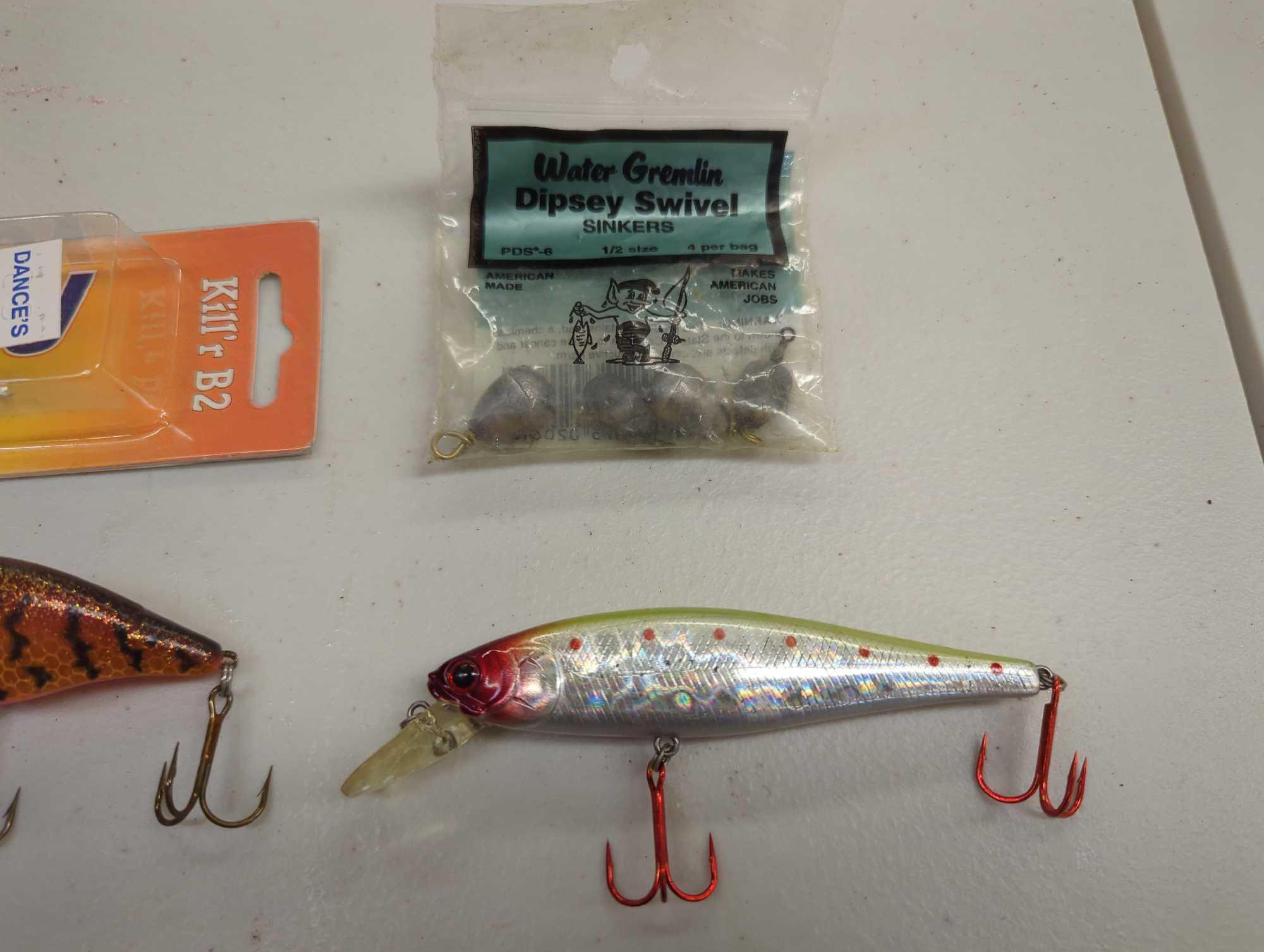 Tackle Box and contents including various fishing lures and other fishing accessories. Comes as is
